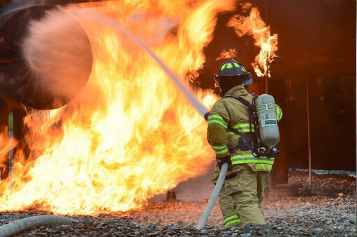 Firefighter putting out a fire in "in-house" fire training