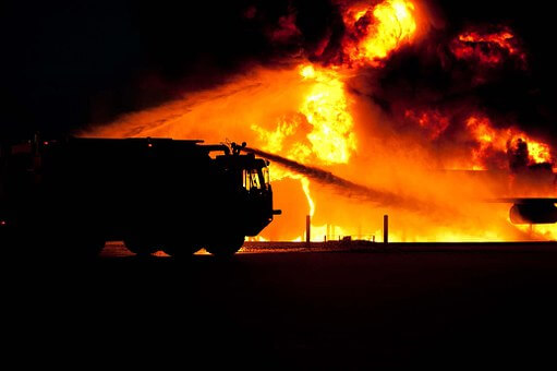 Fire truck with water cannon light by a fire